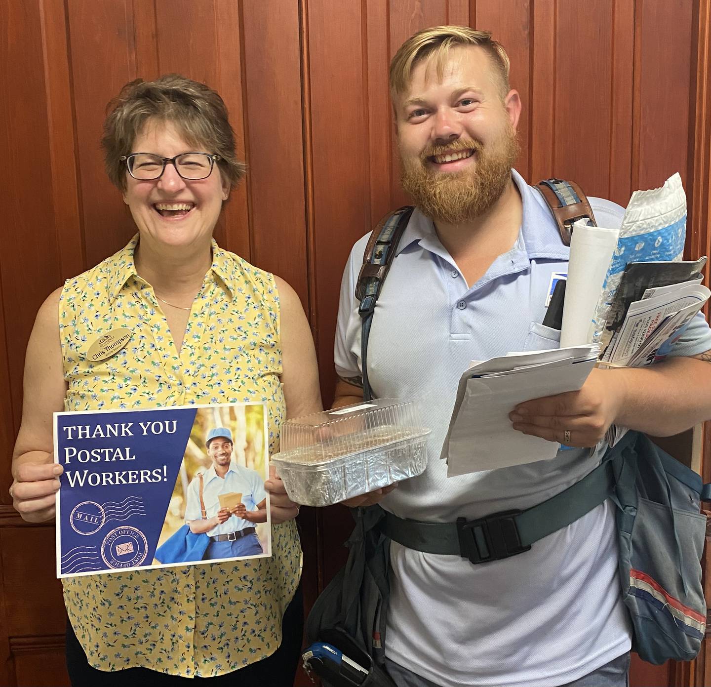 Pictured is Greenfield’s postal carrier Hunter and activity director Chris Thompson.