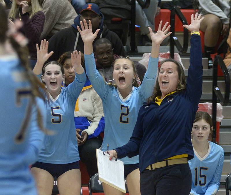 The Marquette Lady Crusader bench and head coach Mindy McConnaughhay celebrate a comeback attempt in the 2nd set Tuesday against Lexington at the Woodland Sectional.