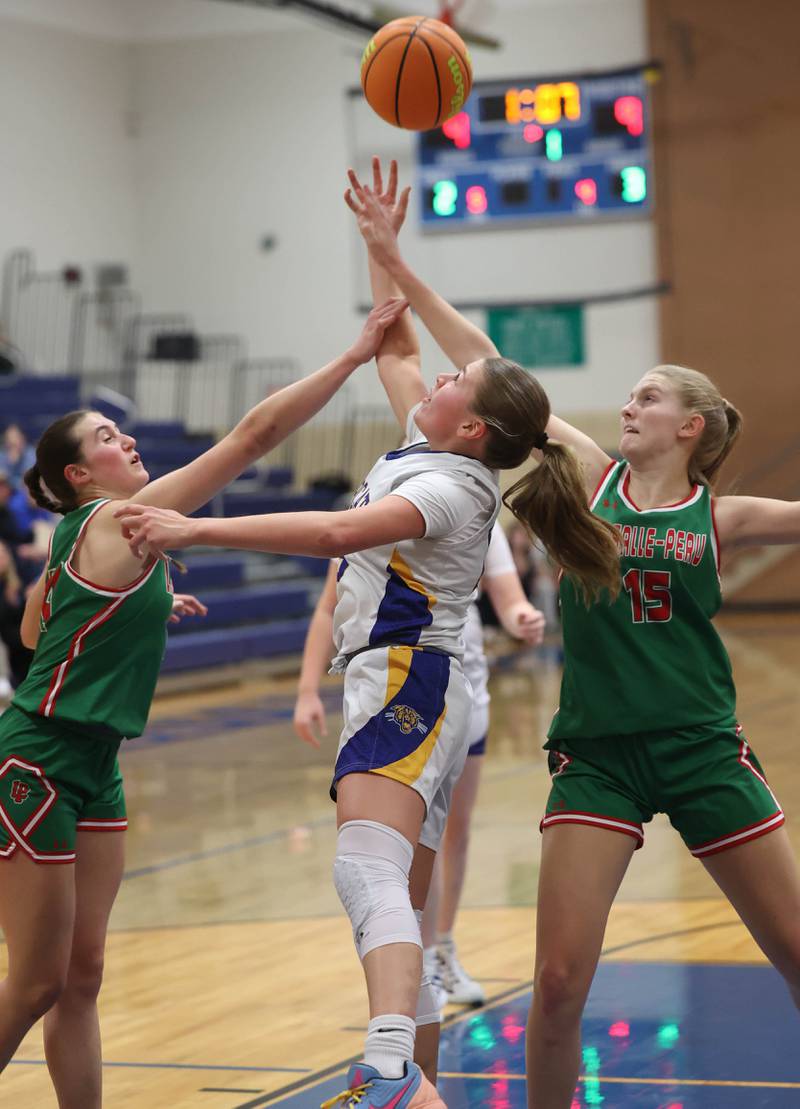Somonauk-Leland's Kiley Mason goes after a rebound between La Salle-Peru's Drew Depenbrock (left) and Margaret Boudreau during their game Thursday, Nov. 20, 2025, in the Tim Humes Breakout girls basketball tournament at Somonauk High School.