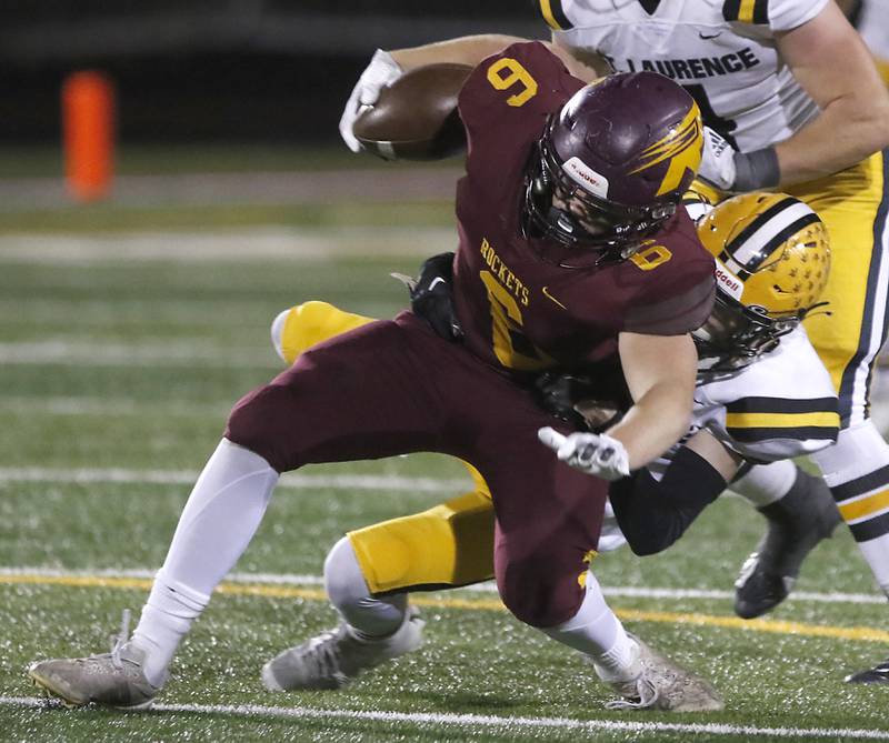 Richmond-Burton's Ryan Wisniewski is tackled by St. Laurence's Mickey Lotus during an IHSA Class 4A first-round football game on Friday, Nov. 1, 2024, at Richmond-Burton High School in Richmond.