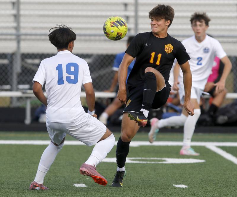 Richmond-Burton’s Nick Kyes kicks the ball away from Woodstock's Christopher Flores during a Kishwaukee River Conference soccer match on Wednesday, Sept. 10, 2025, at Richmond-Burton High School, in Richmond.