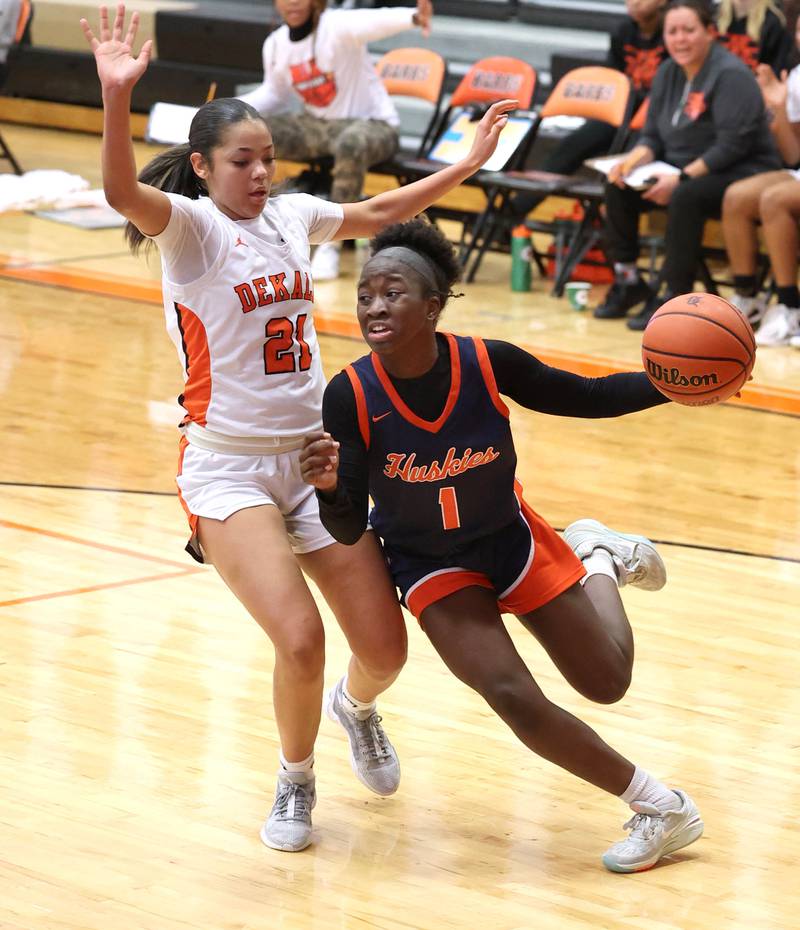 Naperville North's Natalie Frempong goes baseline against DeKalb’s Alicia Johnson Monday, Jan. 22, 2024, during their game at DeKalb High School.