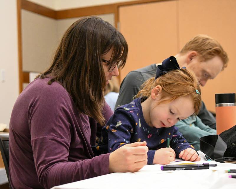 Katie Wilbur and her daughter Joanna Wilbur, 4, of Elmhurst help make handmade cards to send to foster homes on Monday Jan. 20, 2025, during the Martin Luther King Jr. Day of Service.