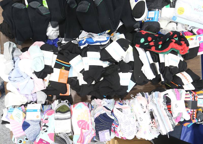 A view of a table full of a large pile of socks during the Shoes and Socks Giveaway on Saturday, Aug. 2, 2025 at the Second Story Teen Center in Princeton. A total of 1,250 socks were donated to give to kids in need.