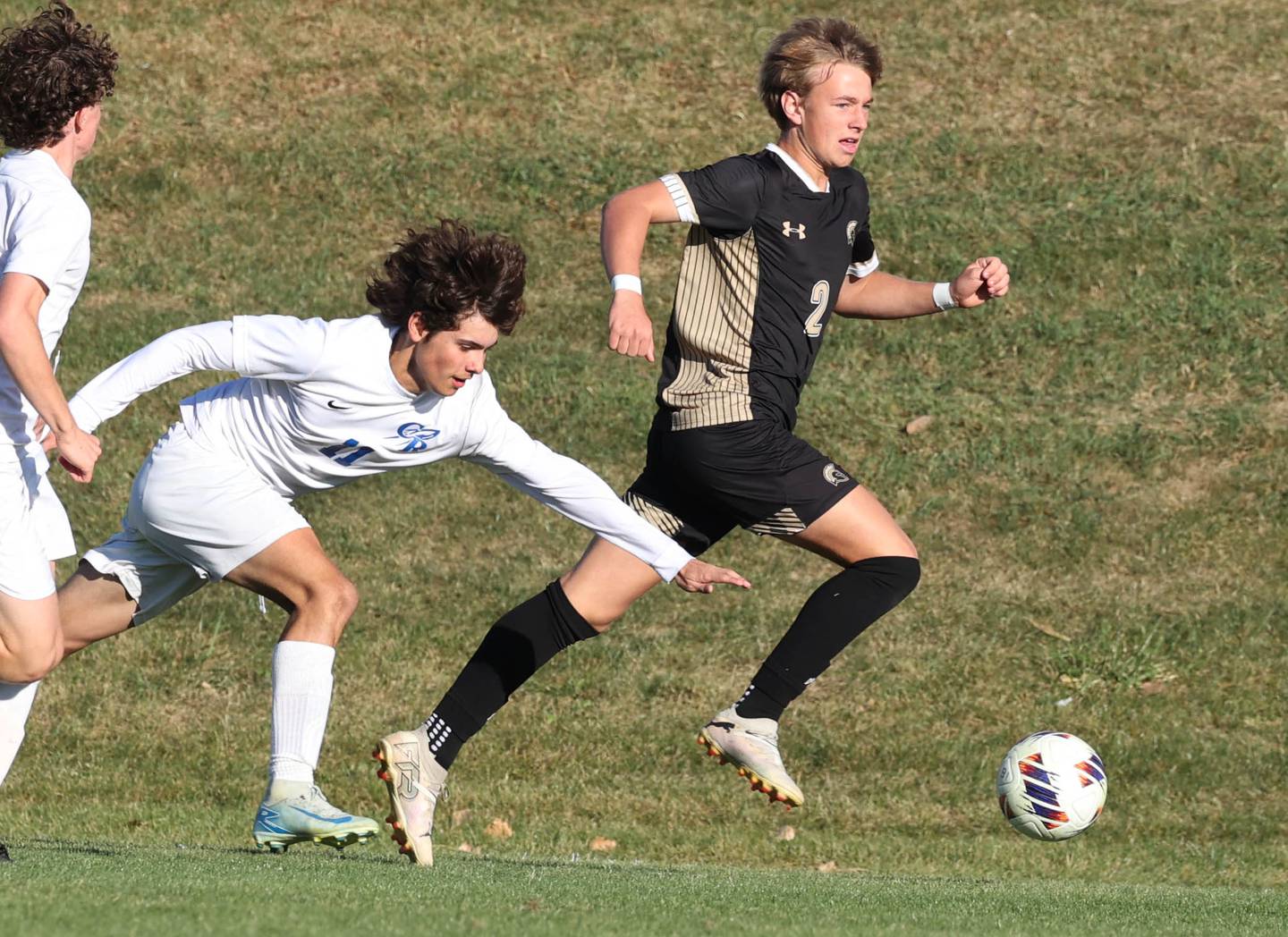 Sycamore's Gavin Crouch carries the ball ahead of a tumbling Burlington Central player Wednesday, Oct. 23, 2024, during their Class 2A Sycamore Regional semifinal.