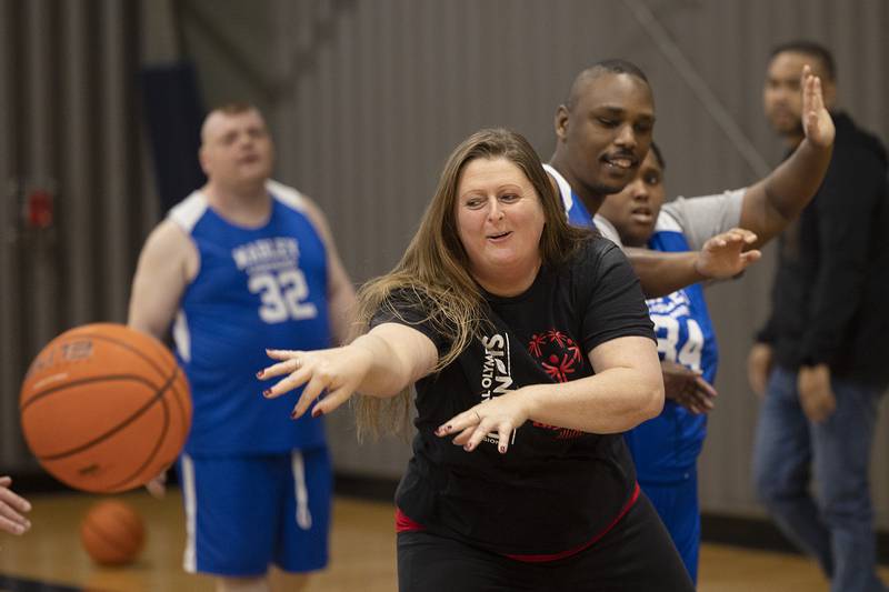 Coach Sarah Heather makes a pass during defense practice Wednesday, Dec. 18, 2024, in Dixon.