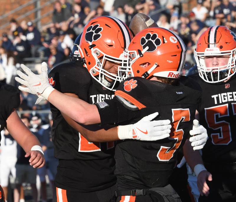 Byron's Kole Aken (5) and JJ Edmonson (27) celebrate after Aken's touchdown against Elmhurst IC Catholic during 3A quarterfinals at Byron High School on Saturday, Nov. 15, 2025.