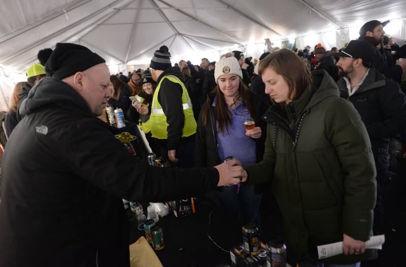 Mike Buchenauer serves beers including a New School Sour from Go Brewing of Naperville to Westmont Park District's Winter Beer Festival attendees including (left) Bridget O'Toole of Downers Grove and Beka Valazques of Washington, IL Saturday, Feb. 15, 2025.