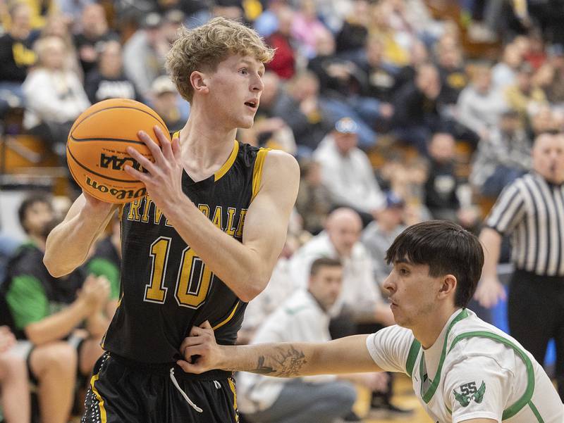Riverdale’s Brody Clark looks to pass against Rock Falls’ Austin Castaneda Friday, Feb. 28, 2025, during the Class 2A Regional final at Bureau Valley High School.