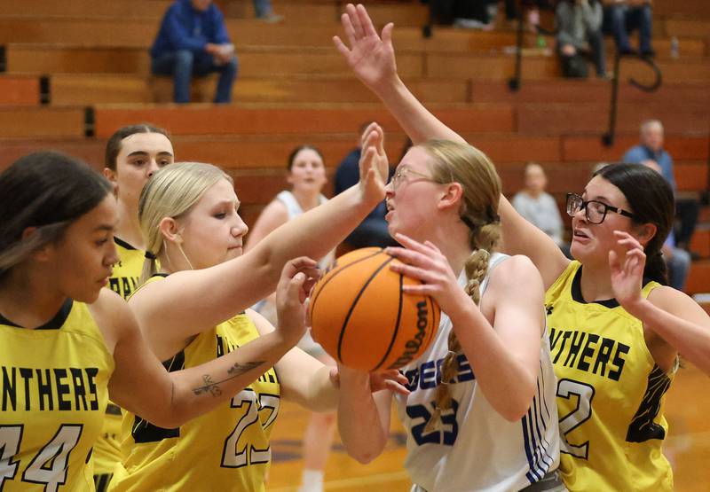 Princeton's Damika Burden, looks to pass the ball off as Putnam County defenders Kaylynn Hill, Emberlyn Cwikla and Addy Leatherman swarm around her during the Tiger Girls Basketball Holiday Tournament on Tuesday, Nov. 18, 2025 at Princeton High School.