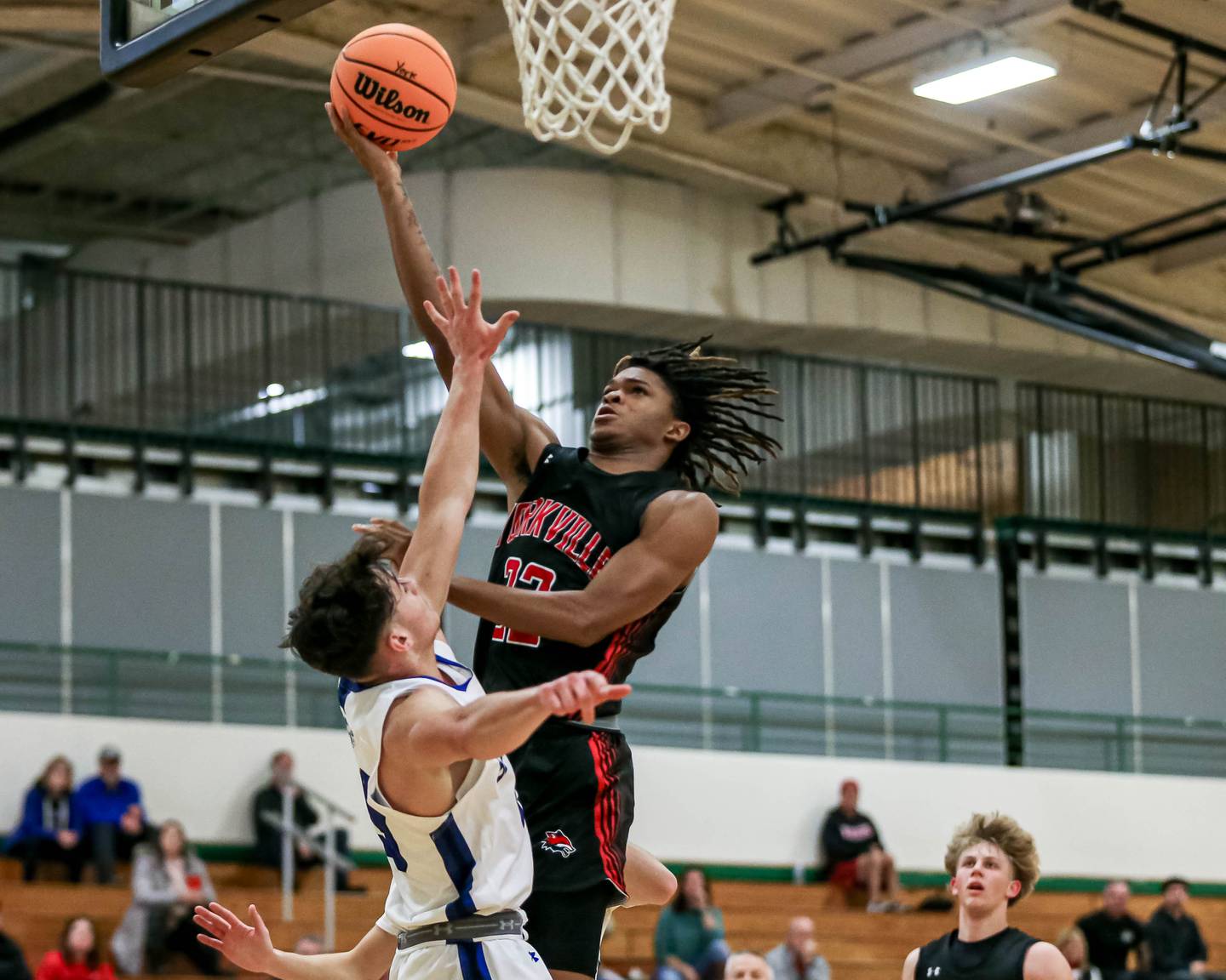 Yorkville's Braydon Porter (22) puts in a contested layup during their Jack Tosh Holiday Classic basketball tournament game between St Francis at Yorkville Thursday Dec 26, 2024 in Elmhurst.