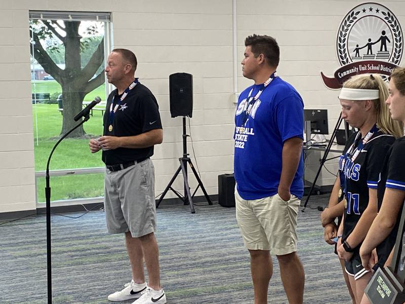 St. Charles North High School softball coach Tom Poulin talks to the St. Charles School Board Monday about the team's first state title. Joining him is fellow softball coach Thijs Dennison.