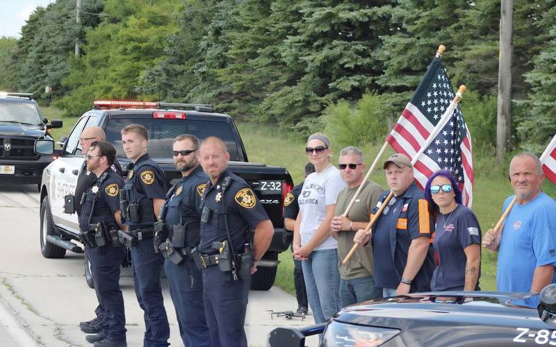 DeKalb County sheriff's deputies and onlookers line up to greet nearly 100 cyclists biking from La Salle County to DeKalb on Saturday, July 12, 2025, for Cycle Across Illinois, a charity campaign to honor fallen police officers and raise funds for their families.