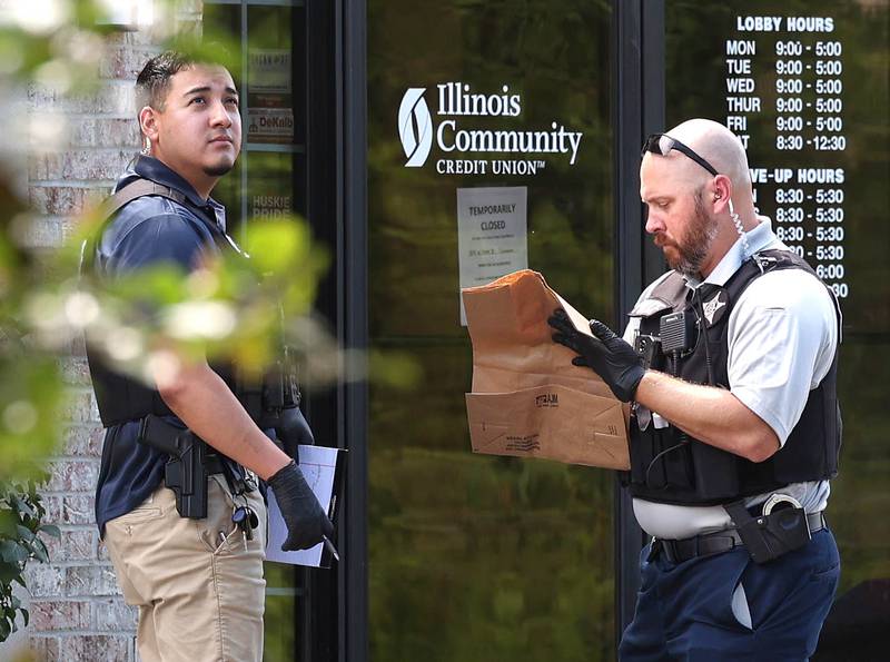 DeKalb police mark bags outside the Illinois Community Credit Union Wednesday, July 31, 2024, as they investigate a morning bank robbery in the facility at 1500 Barber Greene Road in DeKalb.