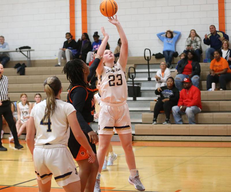 Marquette's Kelsey Cuchra runs in the lane to score on a layup over Manual's Johnneicia Crawley during the Falcon-Irish Thanksgiving Tournament on Monday, Nov. 18, 2024 at Flanagan High School.