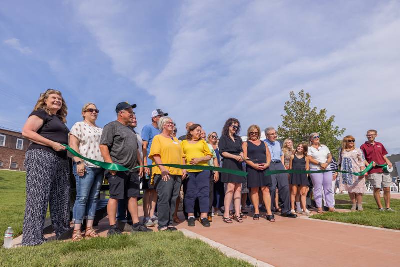 Spring Valley Park Foundation members cut the grand opening ribbon for the lawn furniture at the Spring Valley Mini- Park on August 7, 2025 in Spring Valley.