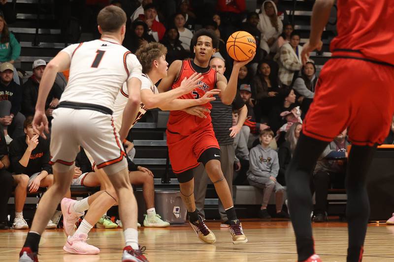 Bolingbrook’s Davion Thompson looks to lob a pass against Minooka on Tuesday, Dec. 17, 2024 in Minooka.