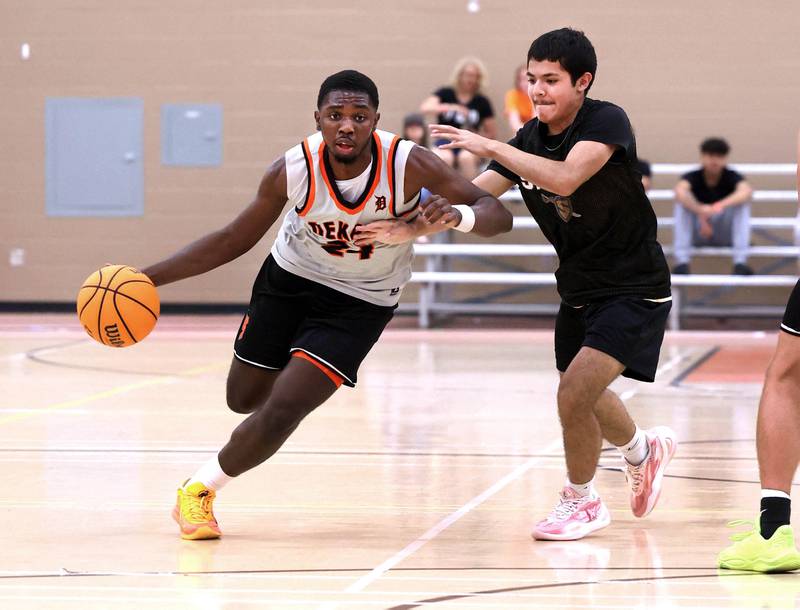DeKalb’s Myles Newman drives by a defender Friday, June 20, 2025, during their game against Streamwood in the DeKalb Live summer tournament at DeKalb High School.