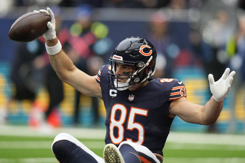 Chicago Bears tight end Cole Kmet (85) celebrates after scoring the first touch down in the first quarter of an NFL football game at the Tottenham Hotspur stadium between the Jacksonville Jaguars and Chicago Bears in London, Sunday, Oct. 13, 2024. (AP Photo/Alastair Grant)