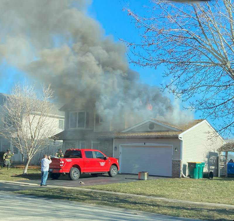Smoke comes from garage roof of house at 1100 Addleman St. in Joliet on Saturday, Feb. 11.