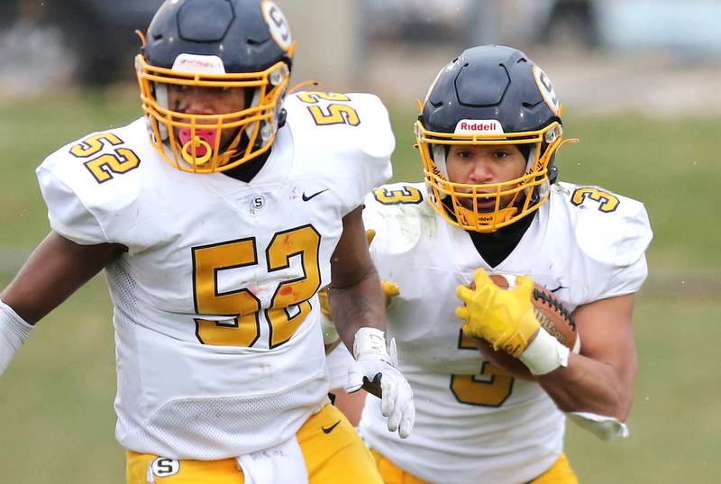 Sterling's Antonio Tablante follows Sterling's Christian Beasley through a hole during their Class 5A state playoff game Saturday, Nov. 12, 2022, at Sycamore High School.