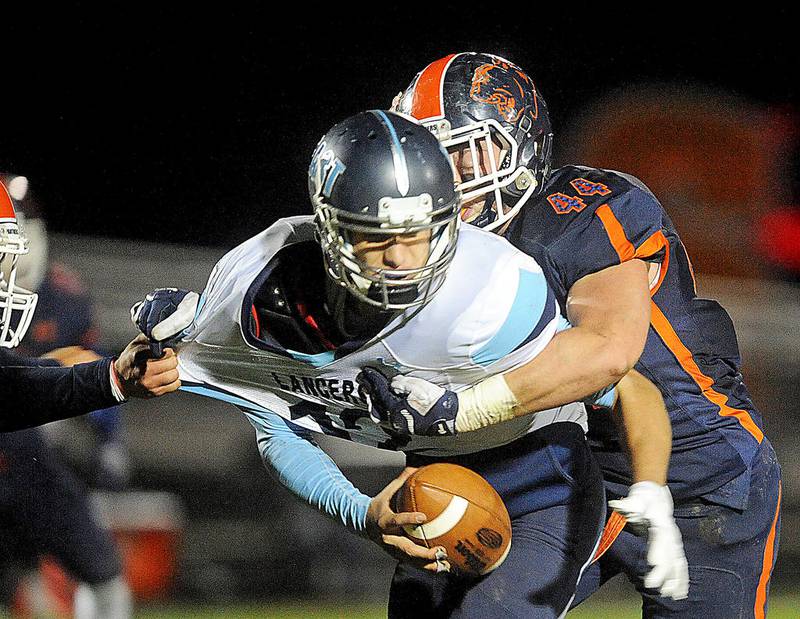 Belleville East quarterback Andrew Millas is sacked by Oswego's Dayne Millard (left) and Brennan Burdo during Friday's Class 8A playoff game against Belleville East at Oswego.