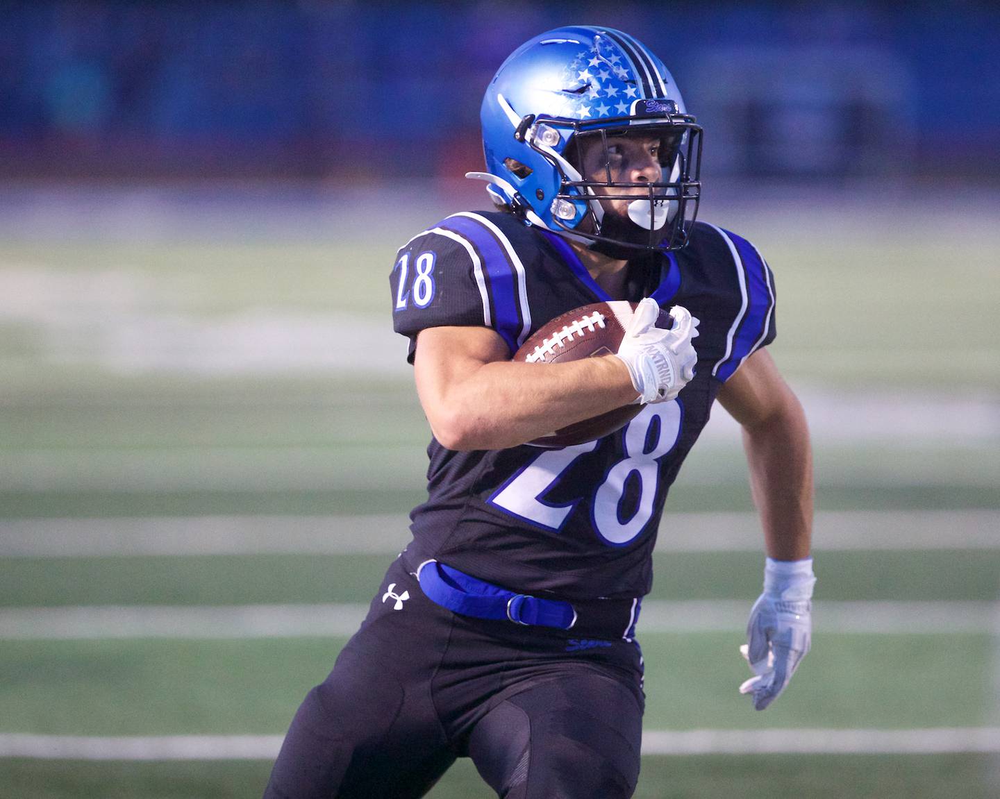 St. Charles North's Carsen Durante carries the ball for a gain against Geneva on Sept. 12, 2025 in St. Charles.