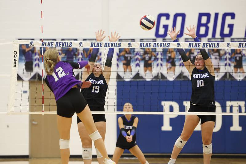 Peotone's Alexa Matichak, right, and Ava Kosmos jump to block a hit by Manteno's Maddy Belisle during the Blue Devils' loss in three sets, 19-25, 25-19, 25-21, to Manteno on Tuesday, Sept. 23, 2025.