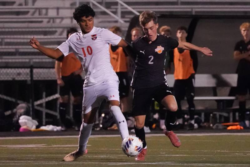 Oswego’s Ariel Cid (10) challenges Wheaton Warrenville South’s Nathan Vassios (2) for the ball during a soccer match at Wheaton Warrenville South in Wheaton on Thursday, Aug 28, 2025.
