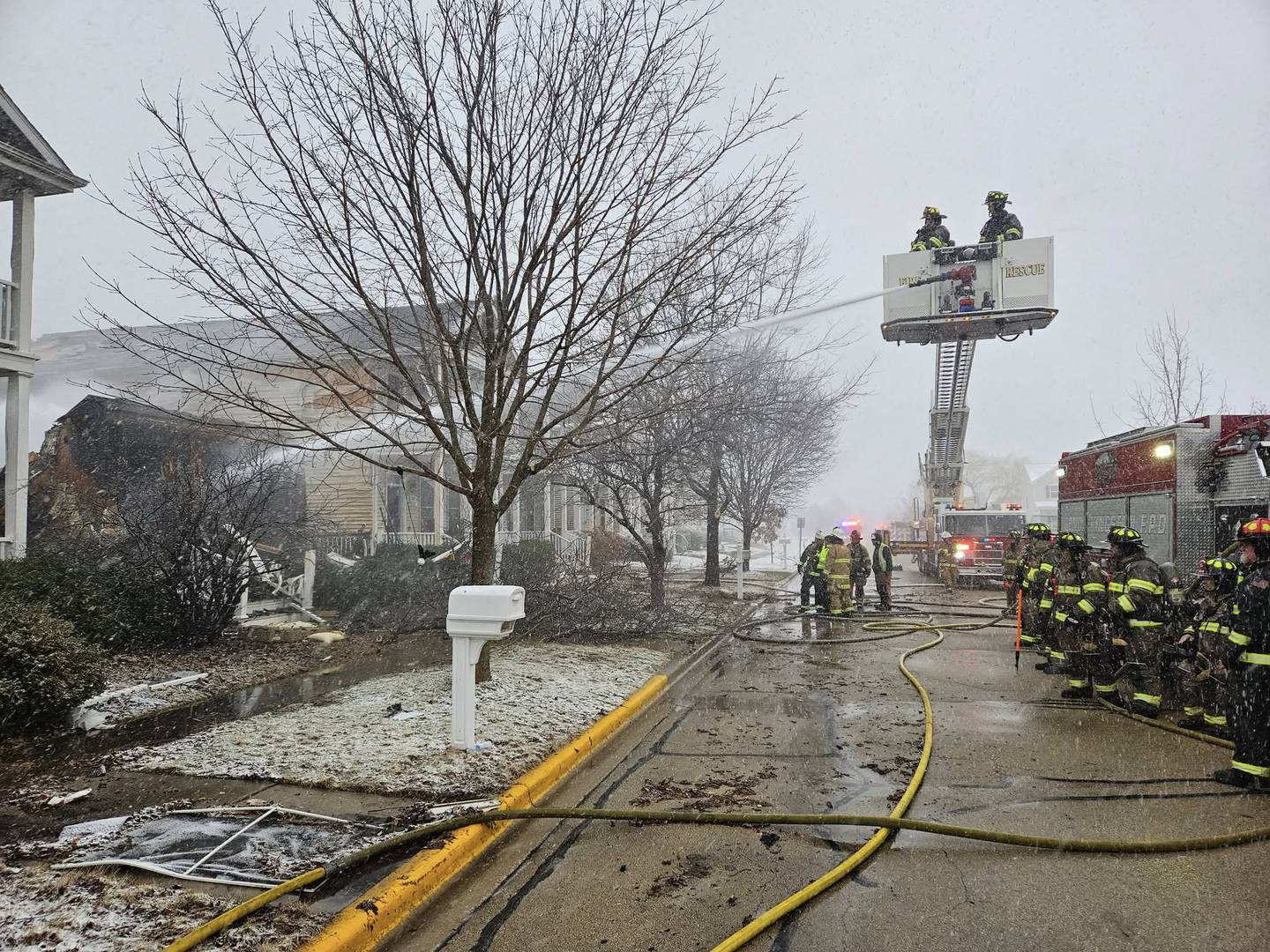 Firefighters from the Genoa-Kingston Fire Protection District battle a multi-home fire in the early morning hours on Sunday, March 16, 2025, in the 200 block of Market Street in the Riverbend Subdivision in Genoa.