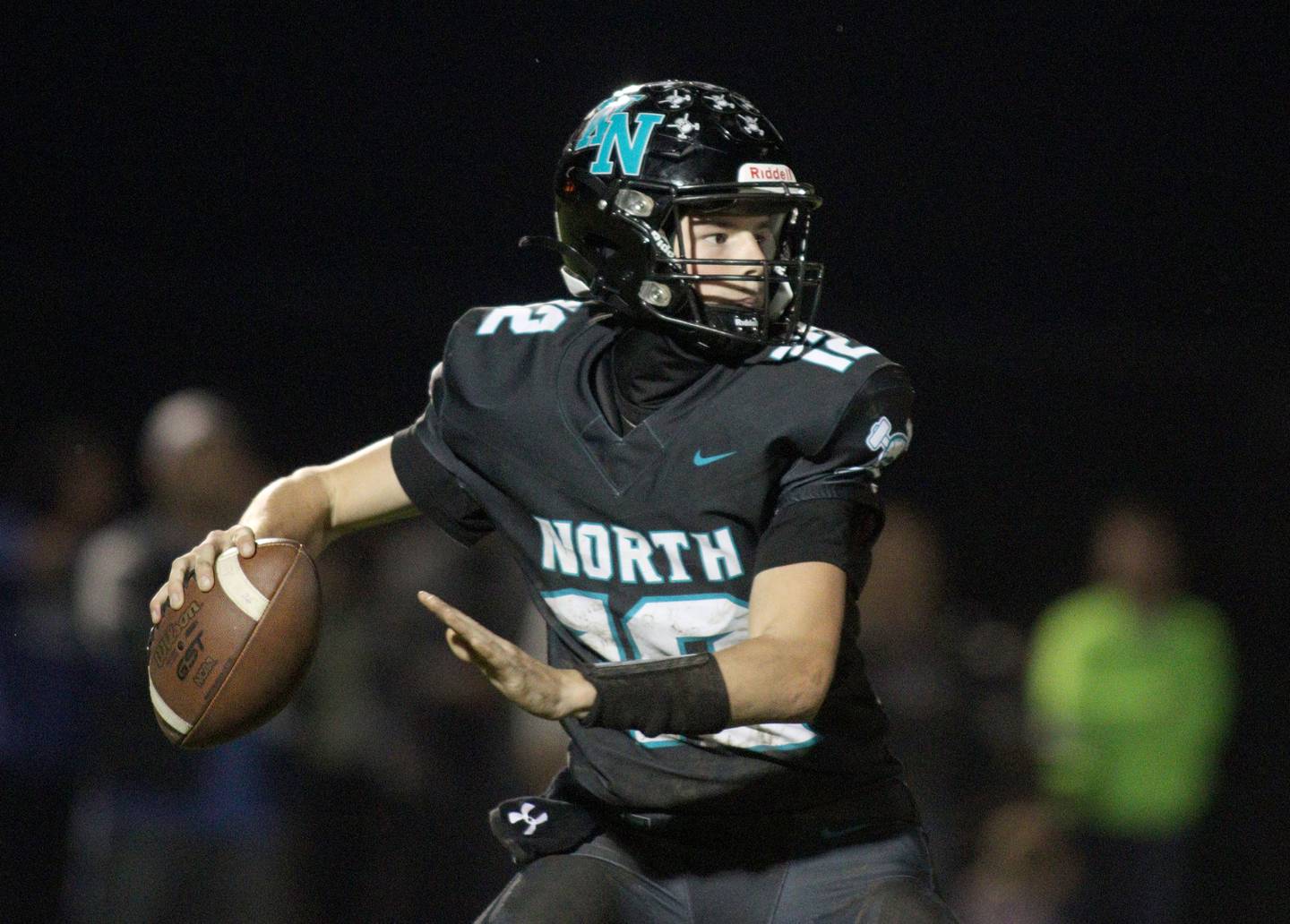 Woodstock North’s Landan Creighton looks for an option against Woodstock in varsity football at Woodstock North Friday night.