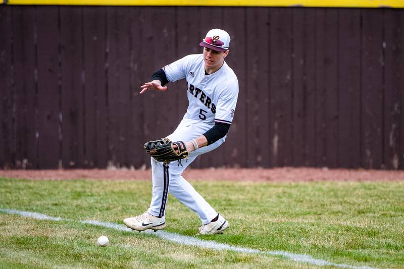 Lockport's Jake Moerman fields a ball  during a game against  Joliet Catholic Academy Friday March 24, 2023 at Flink Field in Lockport