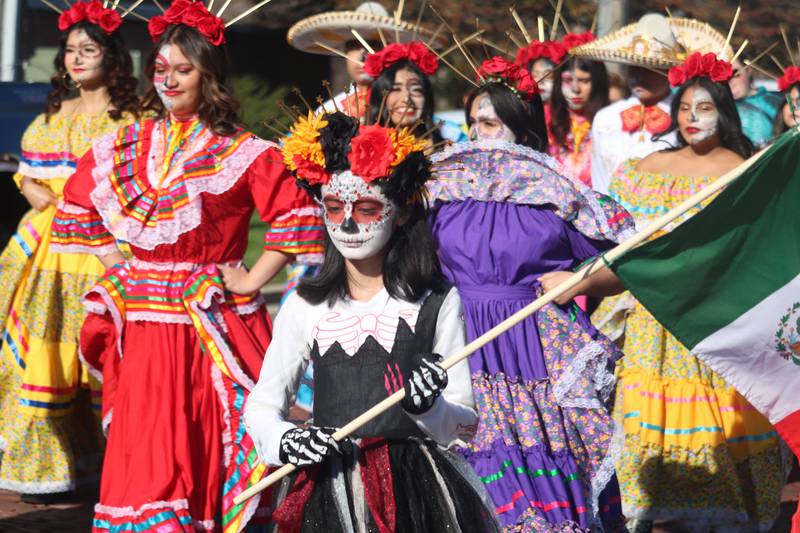 Paraders fill the streets of downtown DeKalb during a procession from the Library to La Calle Bar and Music Venue on Nov. 4, 2023 to kickoff the inaugural Day of the Dead "Celebration of Life."