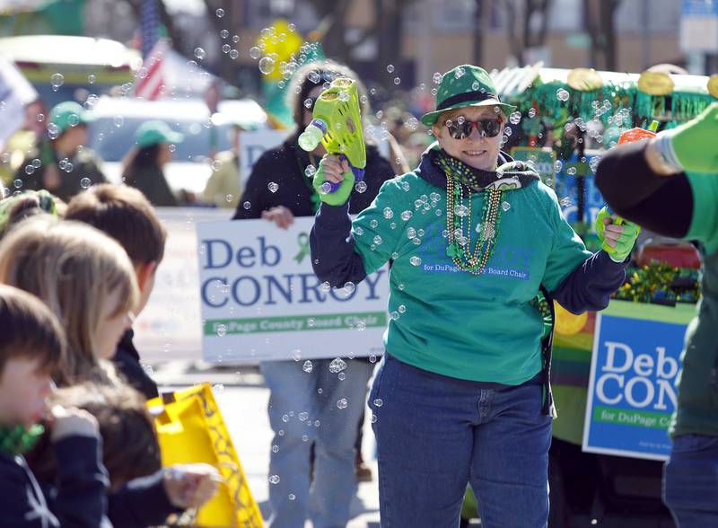 Barbara Omera of Naperville, fills the air with bubbles during the annual St. Patrick’s Day Parade Saturday, March 8, 2025 in Elmhurst Ill.