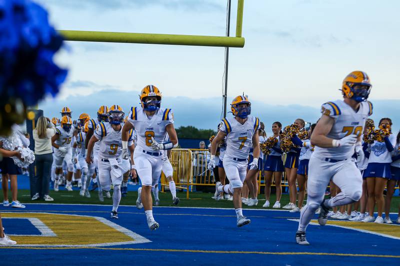 Lyons takes the field before their game versus Hinsdale Central at Lyons Township on Friday, Sept. 8, 2023.