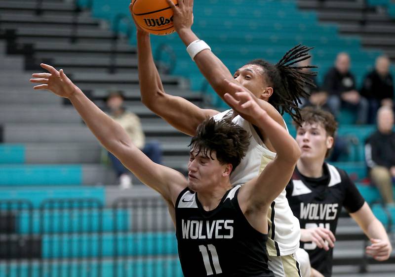 Grayslake North's Rees Jorden grabs a rebound over Prairie Ridge's Elijah Loeding during the 2025 Hoops for Healing tournament basketball game on Wednesday, Nov. 26, 2025, at Woodstock North High School.