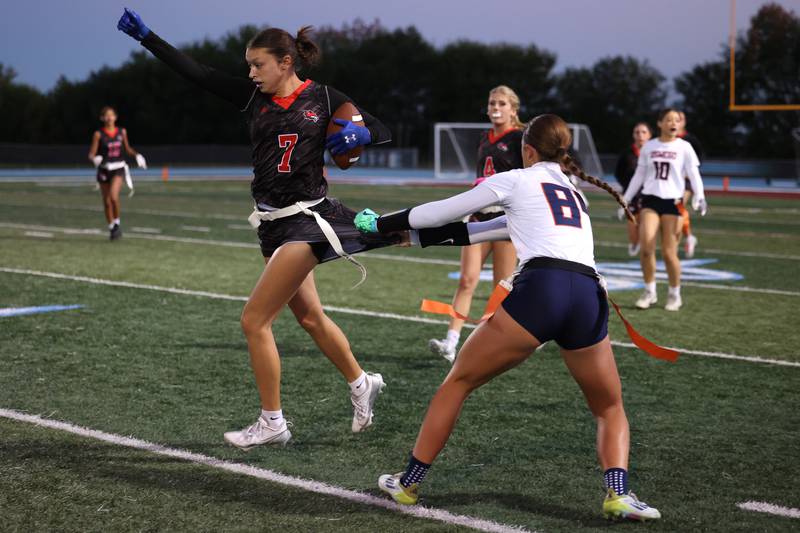 Yorkville's Teaghan Green pivots as Oswego's Sophie Augustine attempts to grab her flag during the Foxes 2-1 overtime victory over Oswego in the IHSA Kankakee Regional championship game on Thursday, Oct. 9, 2025.