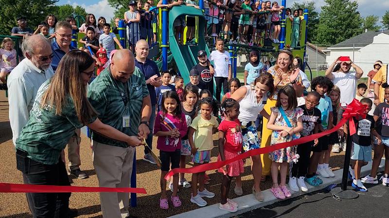 Tony Valenzais. principal at Jamie McGee Elementary School, is  joined by the school community to officially open the renovated school playground in the Valley View School District on Aug. 15, 2023.