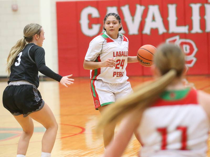 L-P's Jasmine Garman looks to pass to teammate Elizabeth Sines while being guarded by Kaneland's Alexis Schueler on Friday, Dec. 8, 2023 in Sellett Gymnasium at L-P High School.