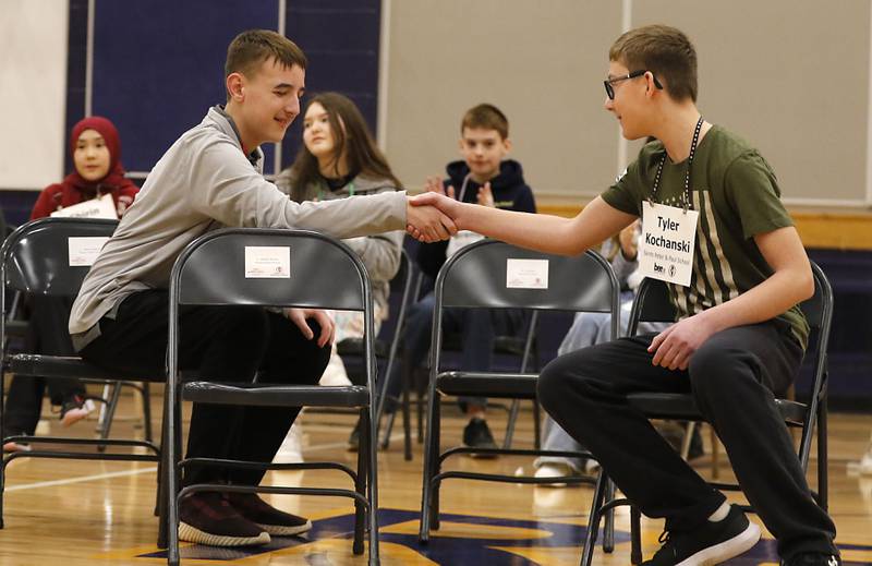 Keegan Schultz (left), a student at Marengo  Community Middle School, shakes hands with Tyler Kochanski from Saints Peter and Paul Catholic School after Kochanski won the McHenry County Regional Office of Education’s 2025 Spelling Bee on Wednesday, March 19, 2025, at Bernotas Middle School in Crystal Lake.
