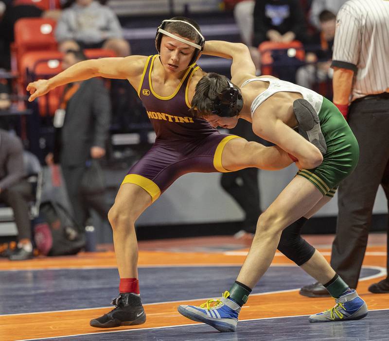 St. Patrick’s Daniel Goodwin grabs the leg of Montini’s Allen Woo in the 113 pound weight class of the 2A state individual wrestling finals Saturday, Feb. 22, 2025, at State Farm Center in Champaign.