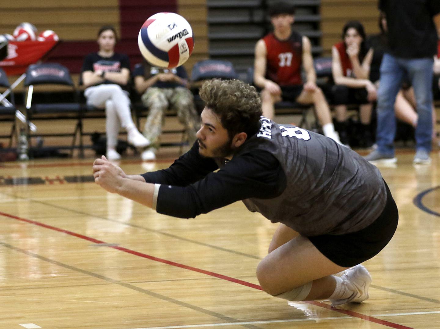 Huntley's Adrian Martinez tries to dig the ball during a nonconference boys volleyball match against St. Charles North Monday, May 8, 2023, at Huntley High School.