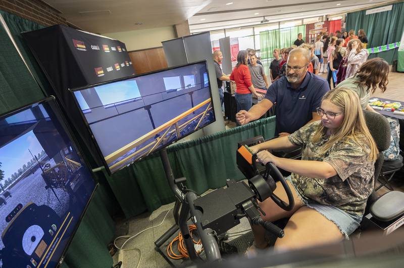 Gold Star FS  representative Alan Baker shows Morrison eighth grader Keagan Bruins the controls for a tractor simulator Friday, Oct. 17, 2025, at Sauk Valley Community College.