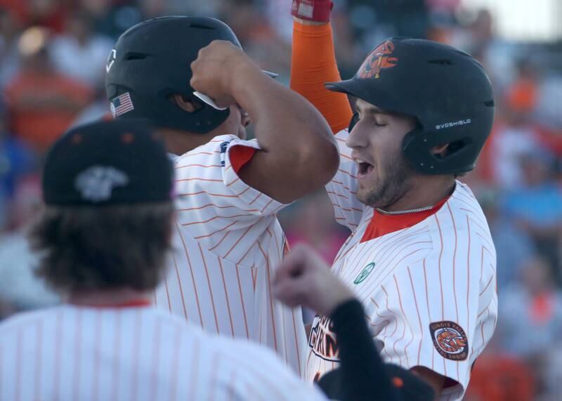 Pistol Shrimp's Ryan Niedzweidz of North Aurora, hi-fives teammates after hitting a solo home run against Rex during the Prospect League Championship Series  on Wednesday, Aug. 7, 2024 at Schweickert Stadium in Peru.