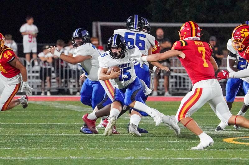 Lincoln-Way East's Braden Tischer (15) carries the ball on a keeper against Batavia during a football game at Batavia High School on Friday, Sep 1, 2023.