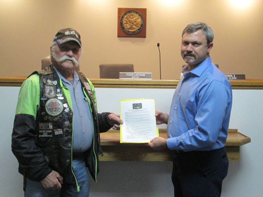 Cliff Oleson, Open Roads ABATE of IL, Inc. Chapter President, pictured left, receives the signed proclamation from Sandwich Mayor Todd Latham.