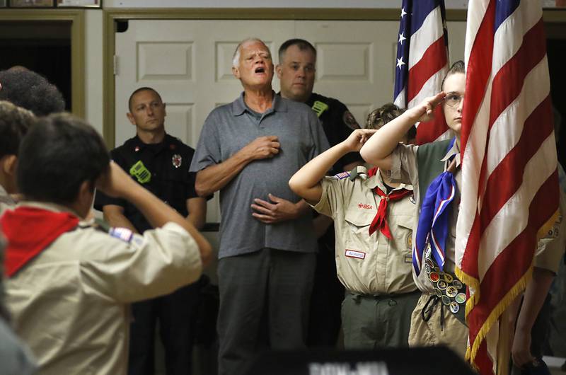 Mark Coleman surrounded by firefighters and Boy Scouts, sings the “National Anthem” during a Sept. 11, Memorial Ceremony, Sunday, Sept. 11, 2022, at the American Legion Post 1231, serving Lake in the Hills and Algonquin, at 1101 W. Algonquin Road in Lake in the Hills. The ceremony included a minute of silence at 10:01 a.m., a 21-gun salute and taps.