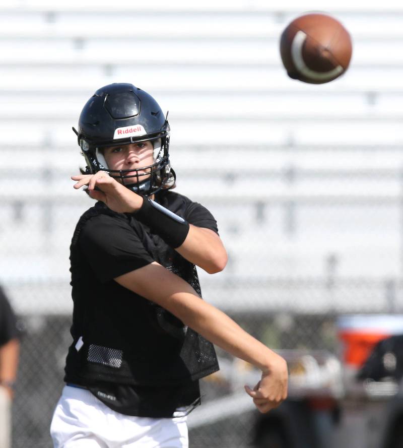 DeKalb quarterback Cole Latimer throws a pass during practice Monday, Aug. 7, 2023, at DeKalb High School.