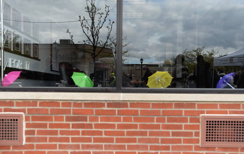 Colorful umbrellas lay along the windowsill of Elmhurst Community Bank during the Umbrella Sky Opening Day Party held Saturday April 29, 2023.