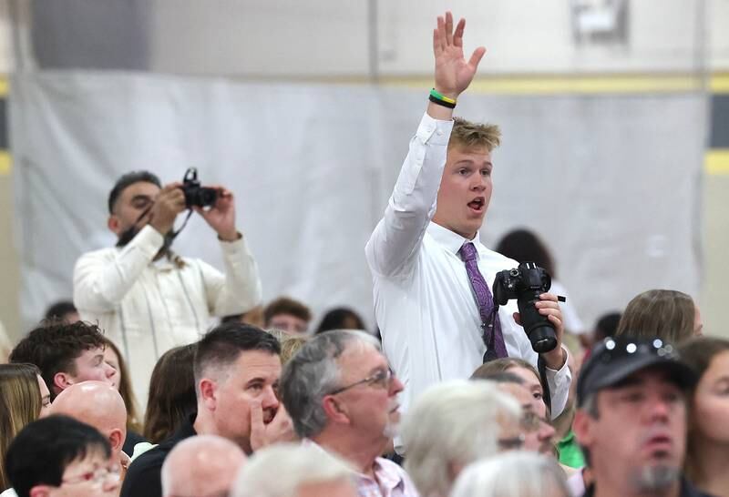 Friends and family wave to graduates and take pictures as they enter for commencement ceremonies Sunday, May 28, 2023, at Sycamore High School.